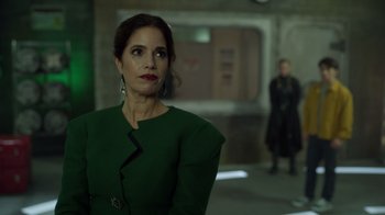 Movie still from “Monster High 2” (2023), directed by Todd Holland – A woman in a green dress looking at the camera; Medium shot, Over the shoulder angle