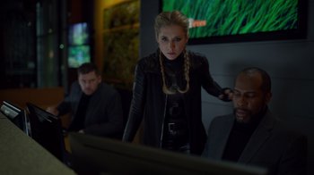 Movie still from “Monster High 2” (2023), directed by Todd Holland – A woman standing in front of a computer screen; Medium shot, Over the shoulder angle