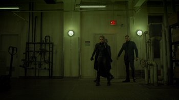 Movie still from “Monster High 2” (2023), directed by Todd Holland – Two men are walking down a hallway in a building; Wide shot, Low angle