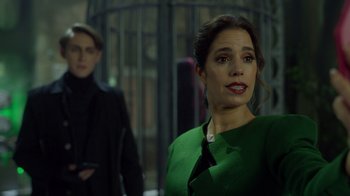 Movie still from “Monster High 2” (2023), directed by Todd Holland – A woman in a green dress standing in front of a man; Close Up shot, Over the shoulder angle