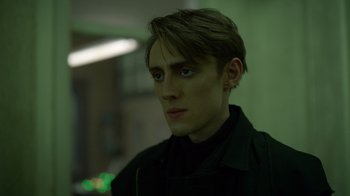 Movie still from “Monster High 2” (2023), directed by Todd Holland – A young man in a black shirt is looking at the camera; Close Up shot, Low angle