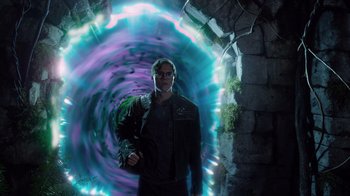 Movie still from “Monster High 2” (2023), directed by Todd Holland – A man standing in front of a tunnel with lights; Wide shot, Over the shoulder angle