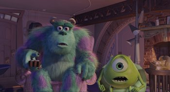Movie still from “Monsters, Inc.” (2001), directed by Pete Docter – Two monsters inc characters sitting on a chair; Medium shot, Low angle