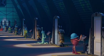 Movie still from “Monsters, Inc.” (2001), directed by Pete Docter – A group of people standing in front of gas pumps; Extreme Wide shot, High angle