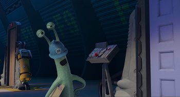 Movie still from “Monsters, Inc.” (2001), directed by Pete Docter – Two cartoon characters in a room with a phone on a desk; Medium shot, Over the shoulder angle