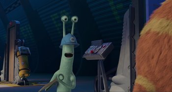 Movie still from “Monsters, Inc.” (2001), directed by Pete Docter – A cartoon character is standing in front of a computer keyboard; Medium shot, Over the shoulder angle