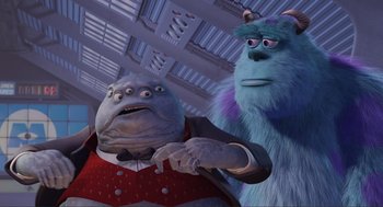 Movie still from “Monsters, Inc.” (2001), directed by Pete Docter – A man and a woman dressed as monsters inc characters; Medium shot, Low angle