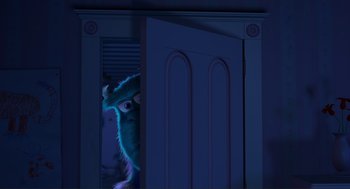 Movie still from “Monsters, Inc.” (2001), directed by Pete Docter – A monster in a blue room looking through a door; Extreme Wide shot, Over the shoulder angle