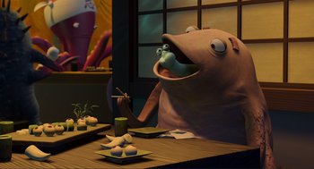 Movie still from “Monsters, Inc.” (2001), directed by Pete Docter – An animated fish sitting at a table in front of a plate of food; Medium shot, Over the shoulder angle