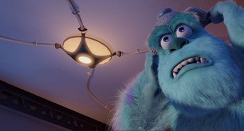 Movie still from “Monsters, Inc.” (2001), directed by Pete Docter – A blue monster with a hat on is looking at a light; Close Up shot, Low angle