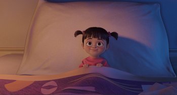 Movie still from “Monsters, Inc.” (2001), directed by Pete Docter – A little girl laying in a bed looking up at the camera; Medium shot, High angle