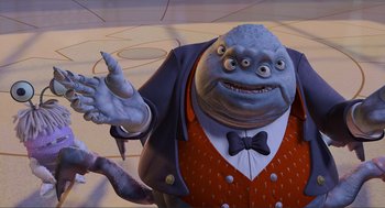 Movie still from “Monsters, Inc.” (2001), directed by Pete Docter – An image of a man that is dressed in a suit; Medium shot, High angle