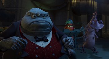 Movie still from “Monsters, Inc.” (2001), directed by Pete Docter – An image of an animated character in a cartoon setting; Medium shot, Low angle