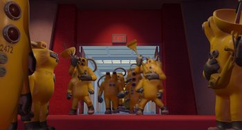 Movie still from “Monsters, Inc.” (2001), directed by Pete Docter – A group of cartoon characters in front of an exit sign; Extreme Wide shot, Low angle
