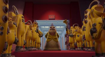 Movie still from “Monsters, Inc.” (2001), directed by Pete Docter – A group of people standing in a hallway with an exit sign above them; Wide shot, Low angle