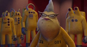Movie still from “Monsters, Inc.” (2001), directed by Pete Docter – A group of people standing next to each other in a room; Medium shot, Low angle