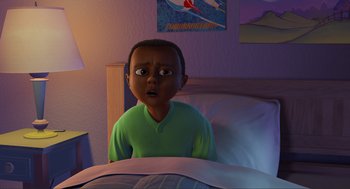 An animated boy is sitting in a bed looking surprised