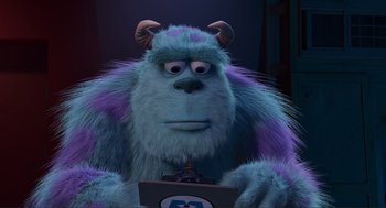 Movie still from “Monsters, Inc.” (2001), directed by Pete Docter – A blue furry monster is holding a computer; Close Up shot, Low angle