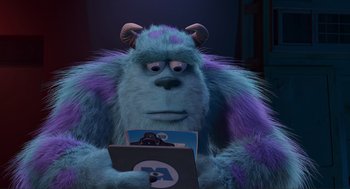 Movie still from “Monsters, Inc.” (2001), directed by Pete Docter – A blue monster holding a laptop in his hands; Close Up shot, Over the shoulder angle