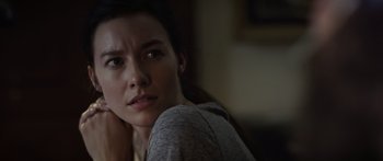 Movie still from “Monsters of Man” (2020), directed by Mark Toia – A person sitting on a couch; Close Up shot, Over the shoulder angle