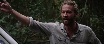 Movie still from “Monsters of Man” (2020), directed by Mark Toia – A man with a beard is pointing in the woods; Close Up shot, Over the shoulder angle