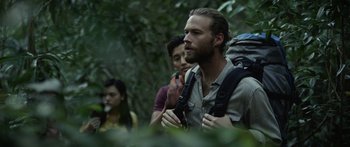 Movie still from “Monsters of Man” (2020), directed by Mark Toia – A group of people in the woods with backpacks; Close Up shot, Low angle