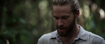 Movie still from “Monsters of Man” (2020), directed by Mark Toia – A person with a beard; Close Up shot, Over the shoulder angle