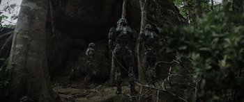 Movie still from “Monsters of Man” (2020), directed by Mark Toia – A group of people standing next to each other in the woods; Extreme Wide shot, Low angle