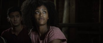 Movie still from “Monsters of Man” (2020), directed by Mark Toia – A young woman looking up into the air; Close Up shot, Low angle