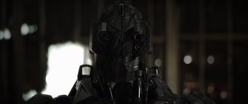 Movie still from “Monsters of Man” (2020), directed by Mark Toia – The face of a black robot; Close Up shot, Low angle