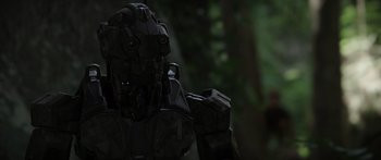 Movie still from “Monsters of Man” (2020), directed by Mark Toia – The head of a robot in a forest; Close Up shot, Low angle