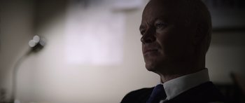 Movie still from “Monsters of Man” (2020), directed by Mark Toia – A man in a suit and a tie; Close Up shot, Over the shoulder angle