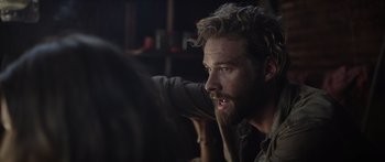 Movie still from “Monsters of Man” (2020), directed by Mark Toia – A man with a long beard is looking into the distance; Close Up shot, Over the shoulder angle