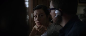 Movie still from “Monsters of Man” (2020), directed by Mark Toia – A woman sitting next to a man in a room; Close Up shot, Over the shoulder angle