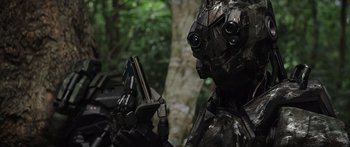 Movie still from “Monsters of Man” (2020), directed by Mark Toia – A man in a suit and helmet is holding a book; Close Up shot, Low angle