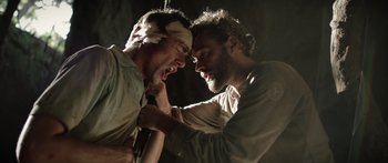 Movie still from “Monsters of Man” (2020), directed by Mark Toia – Two men fighting with each other in a dark room; Close Up shot, Low angle