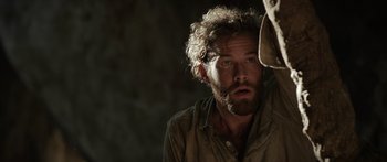 Movie still from “Monsters of Man” (2020), directed by Mark Toia – A man with a beard is looking at the camera; Close Up shot, Low angle