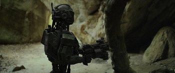 Movie still from “Monsters of Man” (2020), directed by Mark Toia – An image of a man with a gun in a cave; Medium shot, High angle