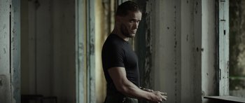 Movie still from “Monsters of Man” (2020), directed by Mark Toia – A person wearing a black t - shirt; Medium shot, Low angle