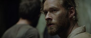 Movie still from “Monsters of Man” (2020), directed by Mark Toia – A person with a beard; Close Up shot, Over the shoulder angle