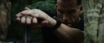 Movie still from “Monsters of Man” (2020), directed by Mark Toia – A person holding a gun; Close Up shot, Low angle