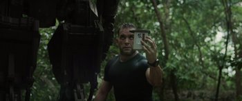 Movie still from “Monsters of Man” (2020), directed by Mark Toia – A man taking a picture of himself in the woods; Close Up shot, Low angle