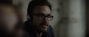 Movie still from “Monsters of Man” (2020), directed by Mark Toia – A person wearing headphones; Close Up shot, Over the shoulder angle
