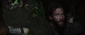 Movie still from “Monsters of Man” (2020), directed by Mark Toia – A man with a beard is looking up at the ground; Close Up shot, Low angle