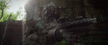 Movie still from “Monsters of Man” (2020), directed by Mark Toia – An image of a robot with a gun in the background; Wide shot, Low angle