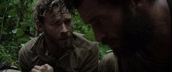 Movie still from “Monsters of Man” (2020), directed by Mark Toia – Two men in the woods talking to each other; Close Up shot, Over the shoulder angle
