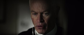 Movie still from “Monsters of Man” (2020), directed by Mark Toia – An older man wearing a suit and tie; Close Up shot, Low angle