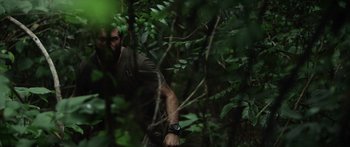 Movie still from “Monsters of Man” (2020), directed by Mark Toia – A man in the middle of the woods looking at the camera; Close Up shot, Over the shoulder angle