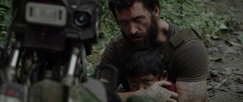 Movie still from “Monsters of Man” (2020), directed by Mark Toia – A man and a child in the woods with a video camera; Close Up shot, Over the shoulder angle