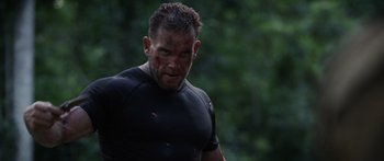 Movie still from “Monsters of Man” (2020), directed by Mark Toia – A person wearing a black shirt with blood all over his face; Close Up shot, Over the shoulder angle